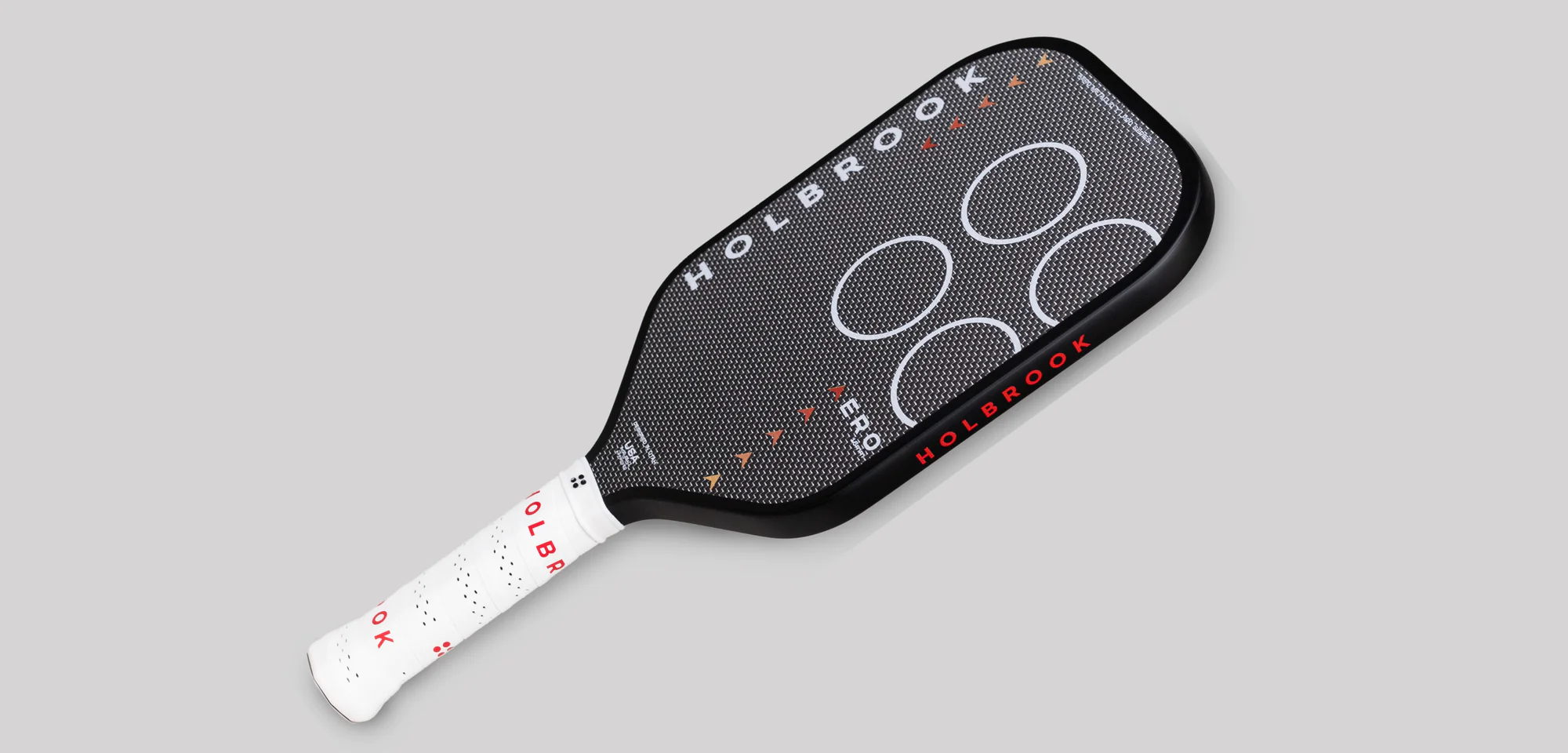 Close-up of Holbrook pickleball paddle face with textured carbon fiber surface and modern aerodynamic design